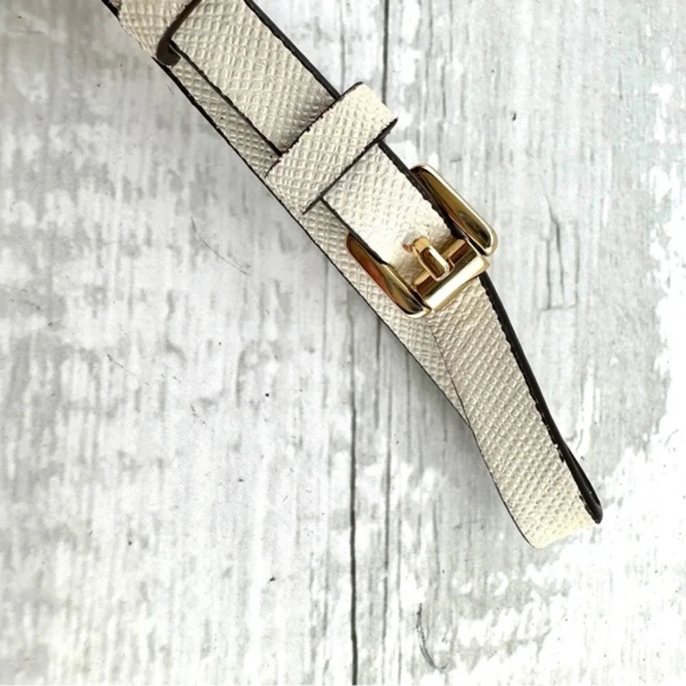 Michael Kors handbag charm.